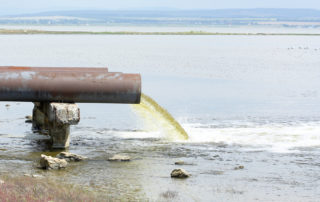 pipe dumping contaminated water in the ocean - Water Pollution in Mississippi