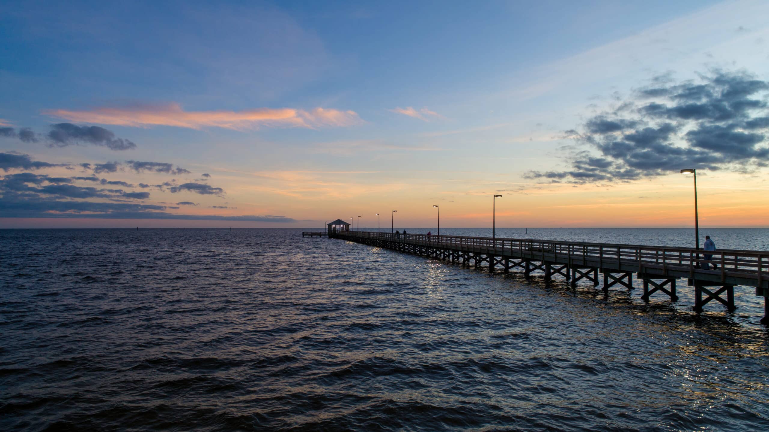 Ocean Springs Mississippi on the Gulf Coast Environmental Law Attorneys portrayed by a long pier out into the Gulf
