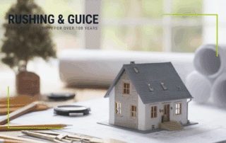 Mississippi Real estate services, Deeds & Title Issues portrayed by a model house sitting on a desk.